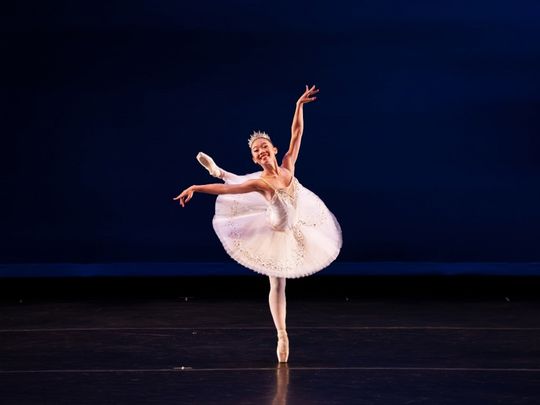 ballerina on center stage in white tutu