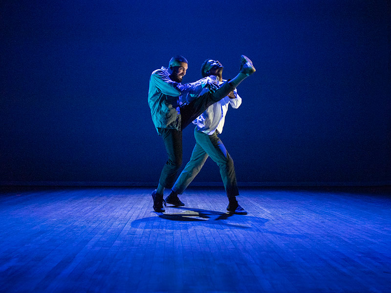 Baye & Asa performing onstage in blue lighting